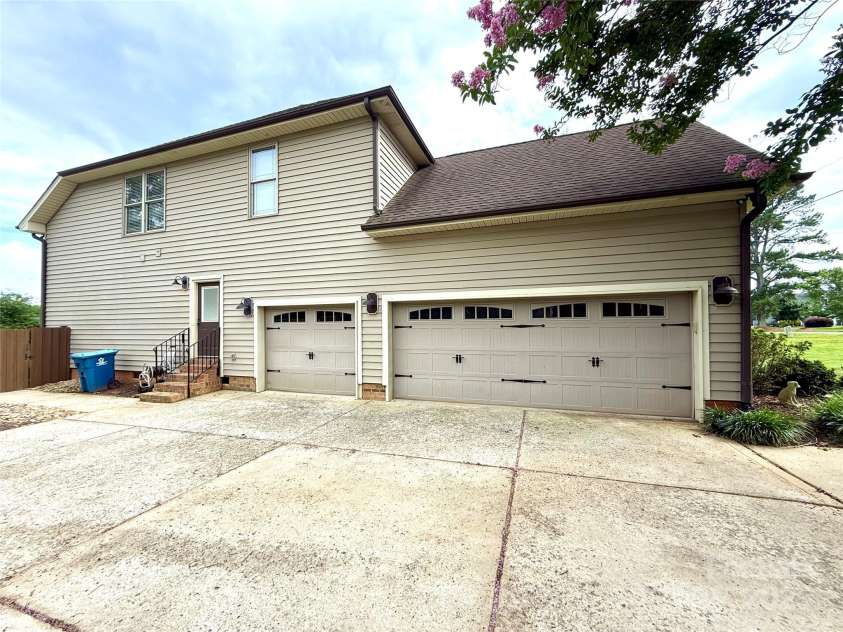141 Weathers Creek Road, Troutman, NC 28166.  MLS# CAR4264721, YatesRealty ID 22900. 3 car attached garage and driveway parking.