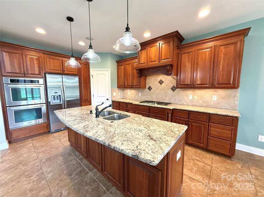 141 Weathers Creek Road, Troutman, NC 28166.  MLS# CAR4264721, YatesRealty ID 22900. Gourmet style kitchen with granite countertops.