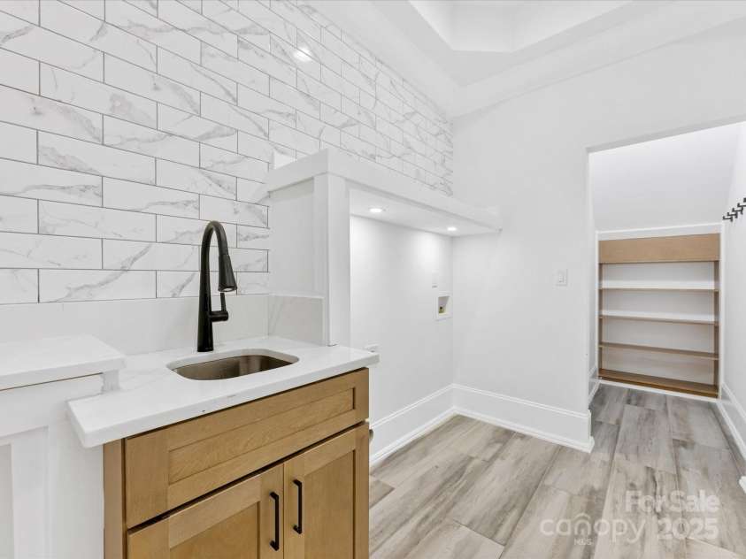 5217 Waterfall Court, Gastonia, NC 28056.  MLS# CAR4268389, YatesRealty ID 22901. First Floor Laundry room with sink and closet area