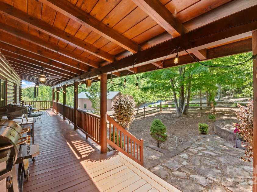 165 Perennial Drive, Nebo, NC 28761.  MLS# CAR4252202, YatesRealty ID 22902. Back porch grilling area leading to fenced in backyard