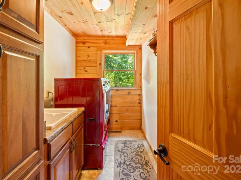 165 Perennial Drive, Nebo, NC 28761.  MLS# CAR4252202, YatesRealty ID 22902. Laundry room with cabinets and storage