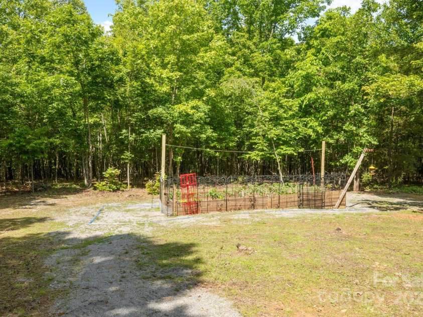 165 Perennial Drive, Nebo, NC 28761.  MLS# CAR4252202, YatesRealty ID 22902. Raised bed area in fenced in area