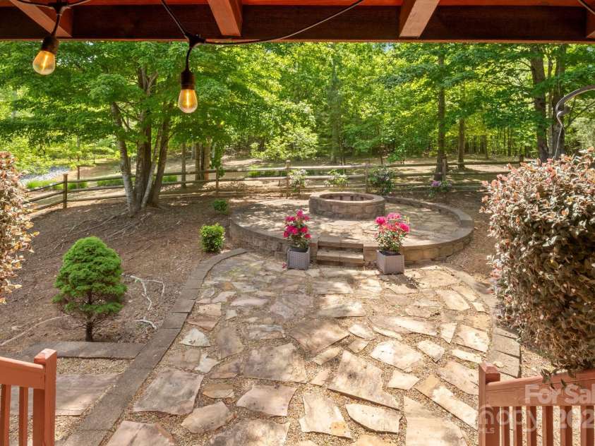 165 Perennial Drive, Nebo, NC 28761.  MLS# CAR4252202, YatesRealty ID 22902. Rock firepit area