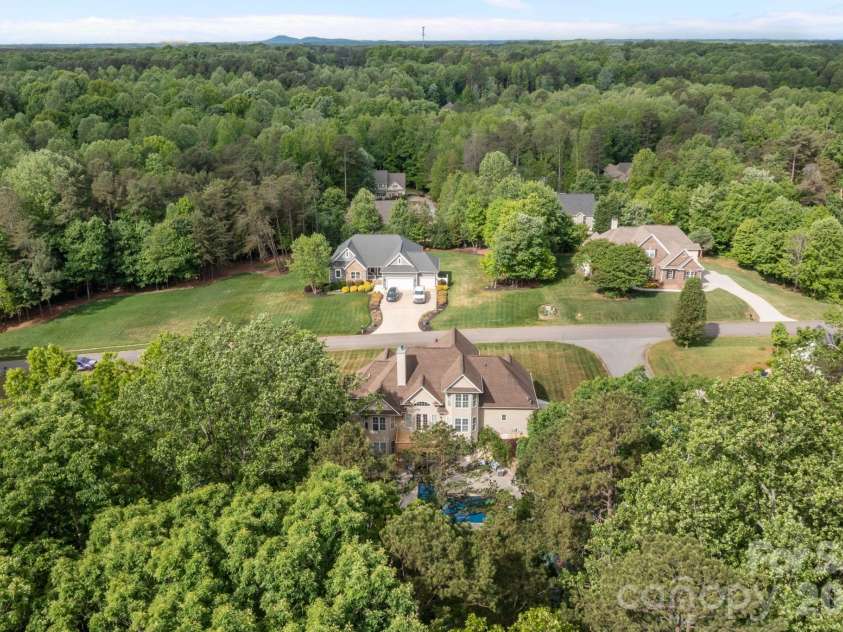 141 Winding Creek Drive, Troutman, NC 28166.  MLS# CAR4353880, YatesRealty ID 22933. Beautiful trees border this spacious and gracious home.