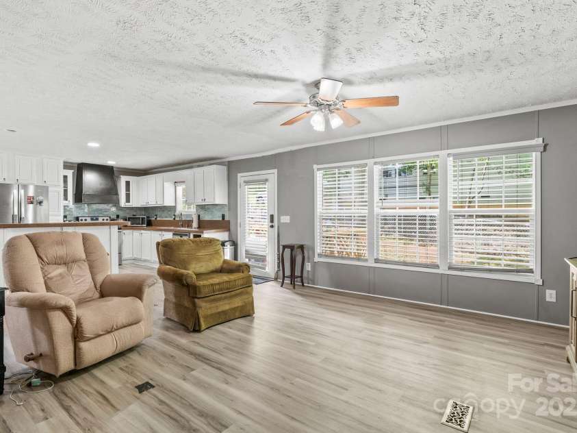 27 Sage Way, Clyde, NC 28721.  MLS# CAR4272722, YatesRealty ID 22936. Entry and living room.