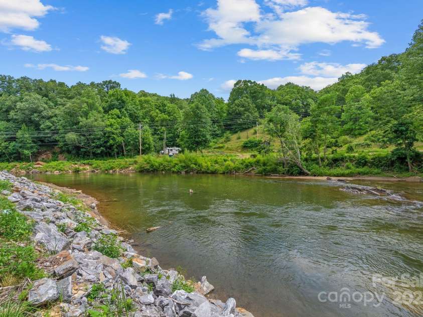 27 Sage Way, Clyde, NC 28721.  MLS# CAR4272722, YatesRealty ID 22936. Pigeon River moments away from the property.
