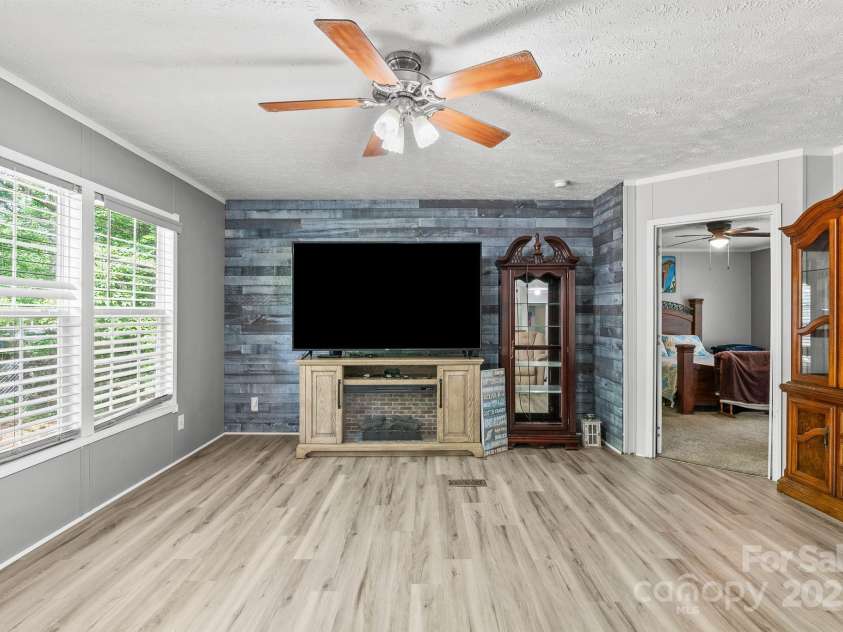 27 Sage Way, Clyde, NC 28721.  MLS# CAR4272722, YatesRealty ID 22936. Shiplap wall in the living room.