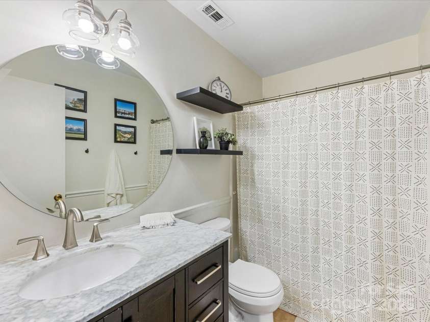 1115 Berry Ridge Road, Charlotte, NC 28270.  MLS# CAR4274309, YatesRealty ID 22944. Full bath with updated vanity, shelving, and lighting!