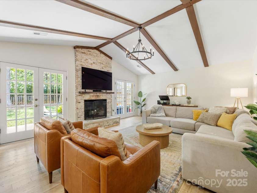 1115 Berry Ridge Road, Charlotte, NC 28270.  MLS# CAR4274309, YatesRealty ID 22944. Wood burning fireplace with french doors on either side for plenty of natural light!