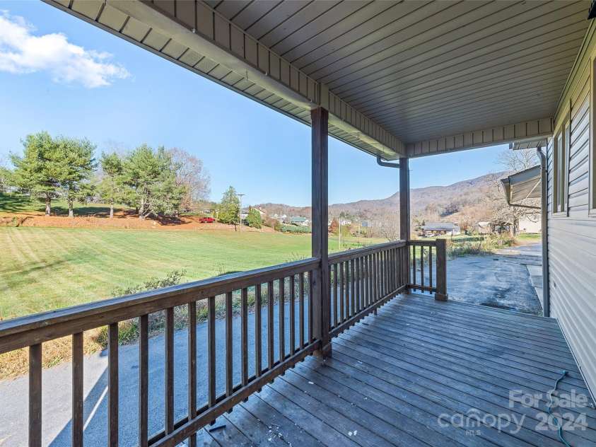 31 Lowe Drive, Waynesville, NC 28786.  MLS# CAR4203338, YatesRealty ID 2296. Covered Front Porch/Deck