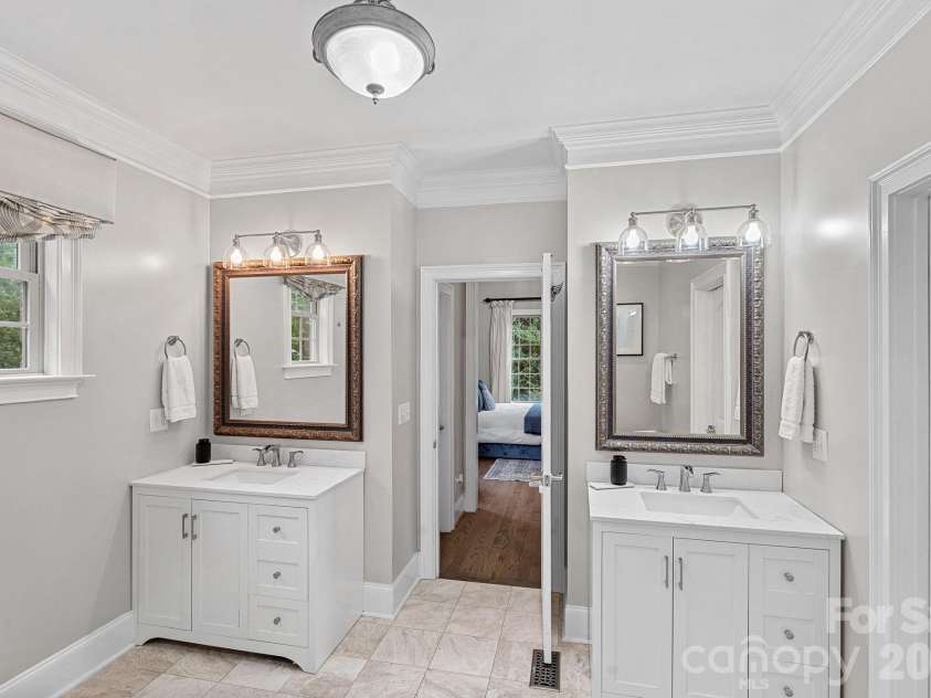 337 Bent Tree Drive, Stanley, NC 28164.  MLS# CAR4377289, YatesRealty ID 22965. Primary Bath vanities with hallway leading to separate closet spaces.