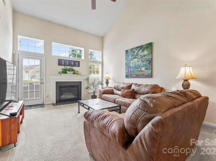 1418 Skidaway Street, Concord, NC 28027.  MLS# CAR4268685, YatesRealty ID 22966. Great room wall of windows, so light and bright.  Gas log fireplace with wall switch control.