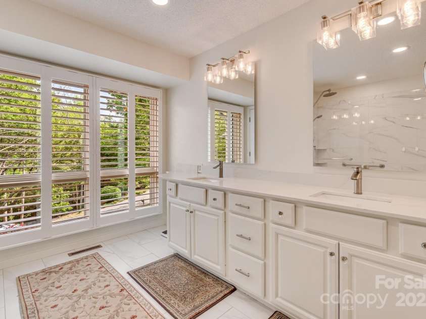 118 Broadmoor Drive, Flat Rock, NC 28731.  MLS# CAR4275218, YatesRealty ID 22968. Come into the updated bathroom with dual vanities.