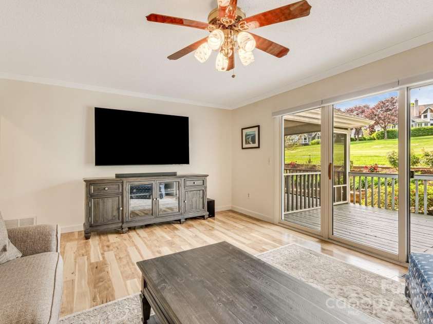 118 Broadmoor Drive, Flat Rock, NC 28731.  MLS# CAR4275218, YatesRealty ID 22968. It's movie time in the den! The den opens to an outdoor deck.