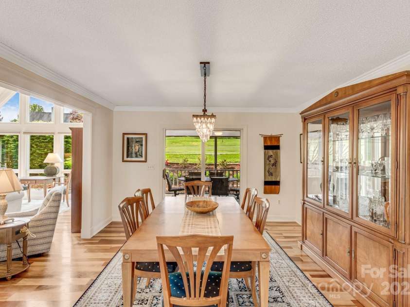 118 Broadmoor Drive, Flat Rock, NC 28731.  MLS# CAR4275218, YatesRealty ID 22968. Thee spacious dining area overlooks the screened in porch.