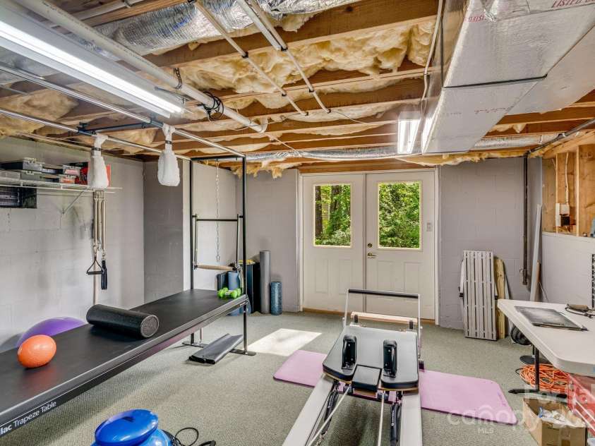 118 Broadmoor Drive, Flat Rock, NC 28731.  MLS# CAR4275218, YatesRealty ID 22968. There is plenty of storage in the basement. Here you see a pliates gym.