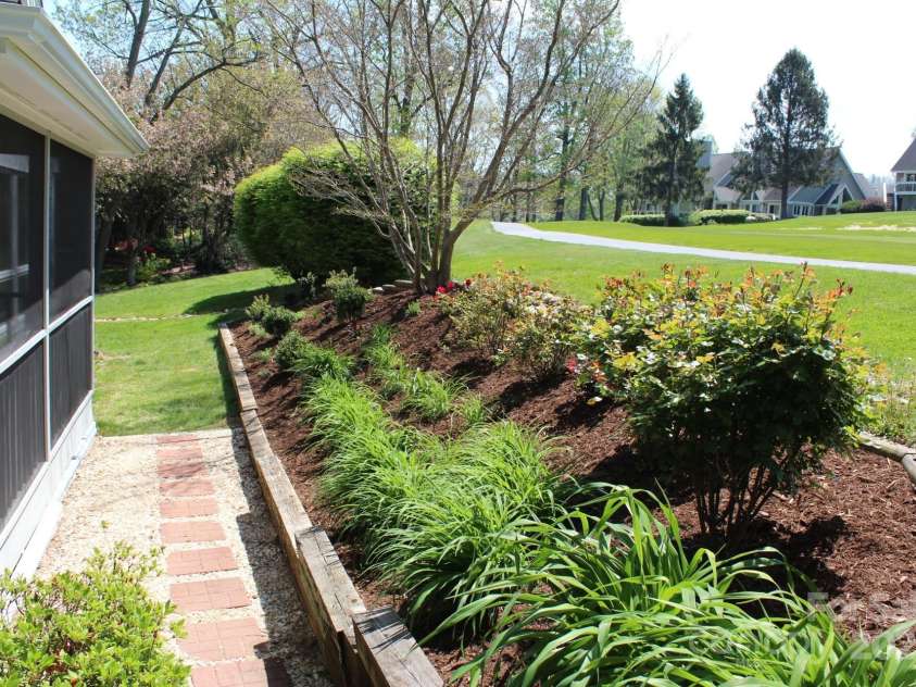 118 Broadmoor Drive, Flat Rock, NC 28731.  MLS# CAR4275218, YatesRealty ID 22968. This newly planted 2025 landscaping enhances the privacy.
