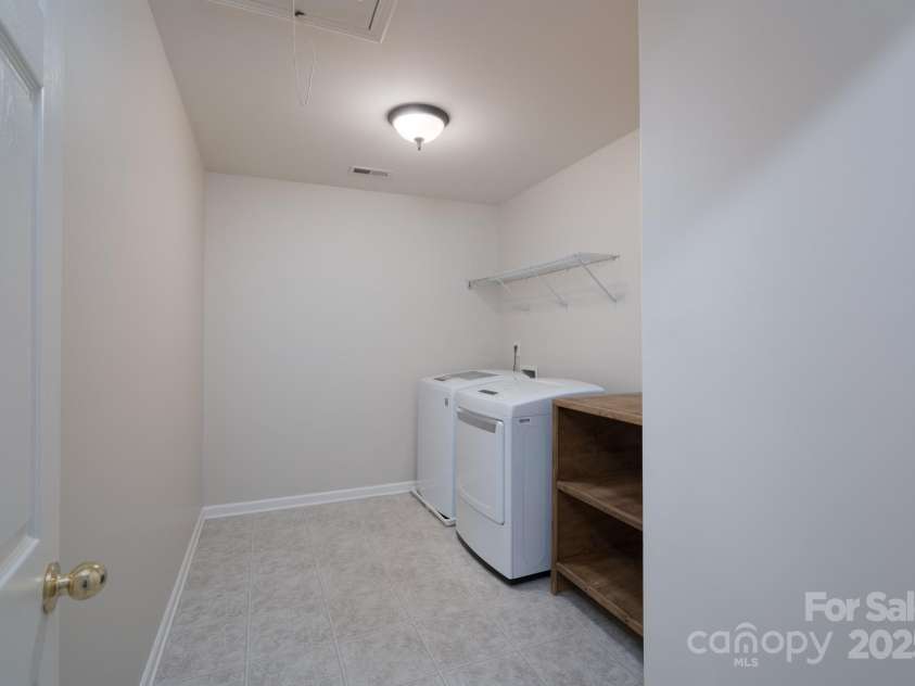 1144 Spicewood Pines Road, Fort Mill, SC 29708.  MLS# CAR4246167, YatesRealty ID 22970. Upstairs large laundry room with attic pull-down stairs