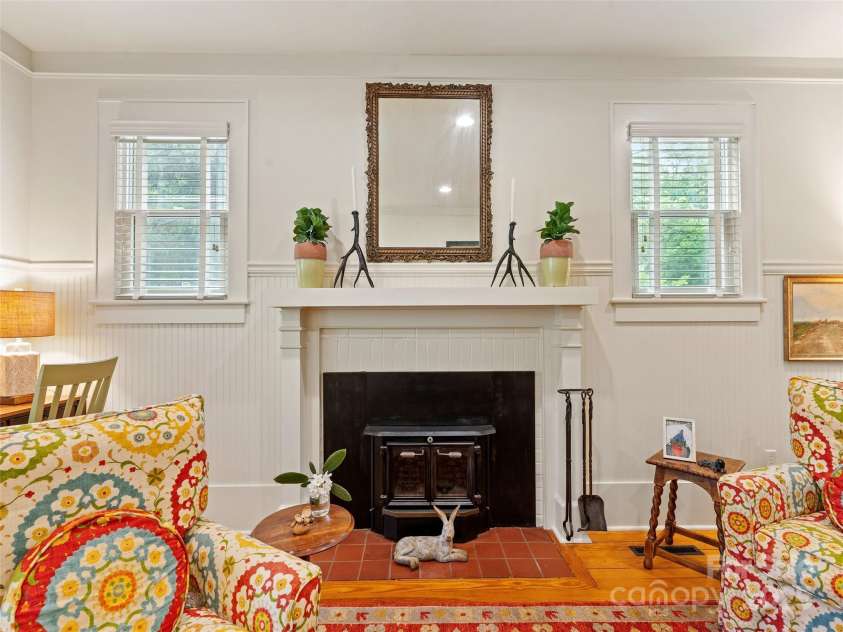 18 Hill Street, Saluda, NC 28773.  MLS# CAR4271722, YatesRealty ID 22979. The living room is made even cozier by a charming wood stove with an updated and improved chimney.