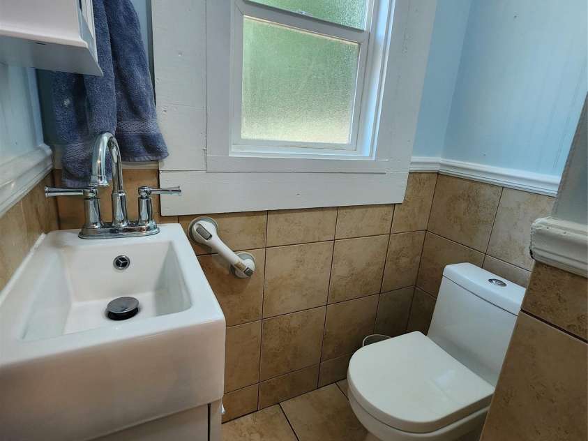 703/705 Smith Street, Kannapolis, NC 28083.  MLS# CAR4275773, YatesRealty ID 22983. 703 side toilet area