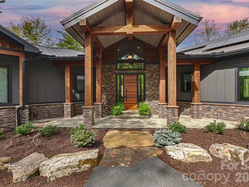 726 Ugugu Drive, Brevard, NC 28712.  MLS# CAR4374214, YatesRealty ID 22985. Inviting covered entryway with well-maintained landscaping.