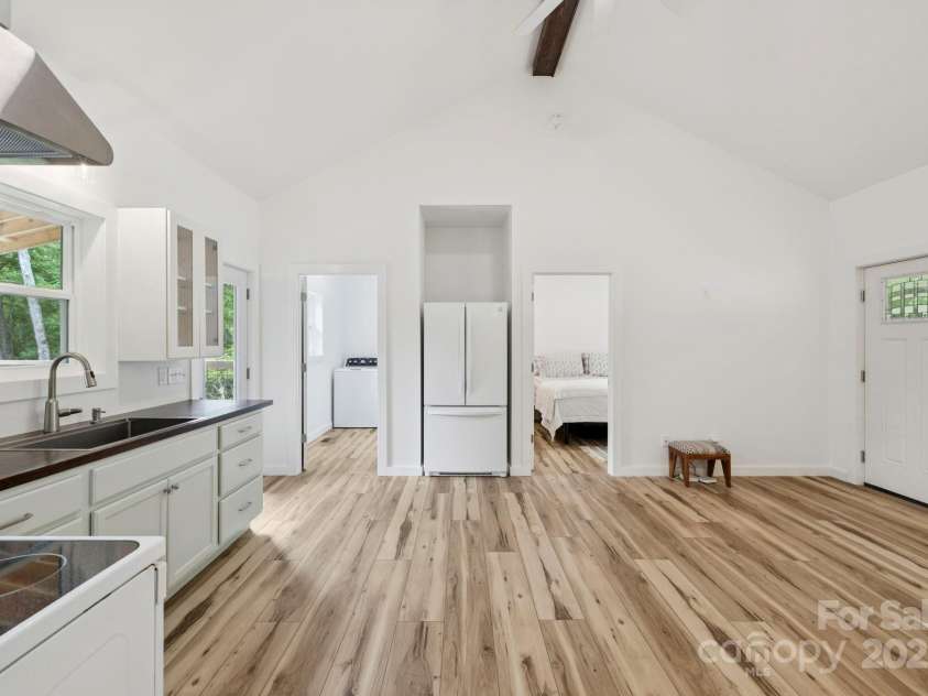 185 Little Elbow Mountain Road, Lake Toxaway, NC 28747.  MLS# CAR4265070, YatesRealty ID 22994. Looking from the kitchen into the guest bedroom and laundry room