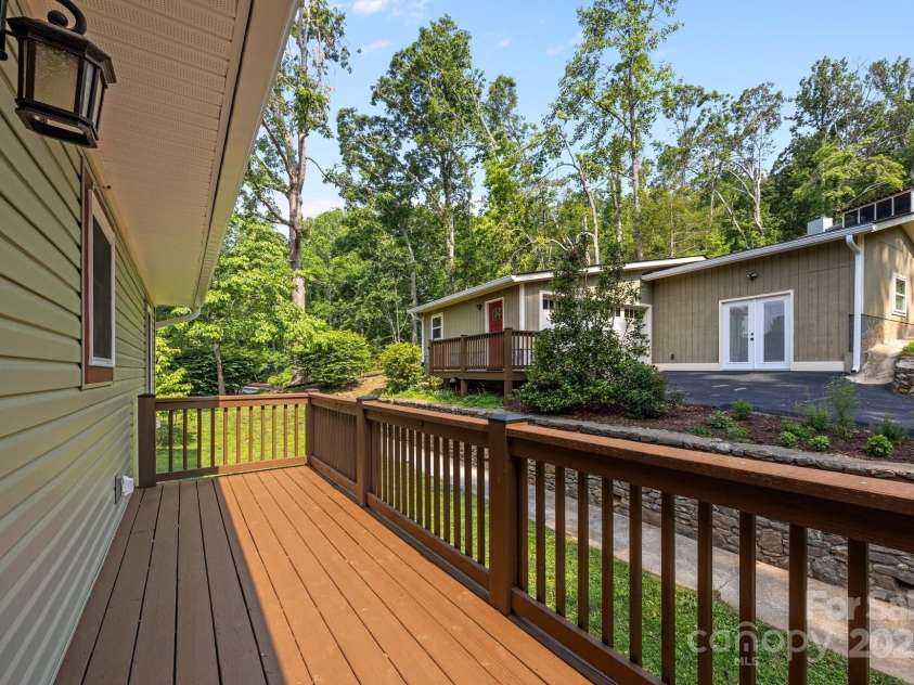 17 Laurel Road, Arden, NC 28704.  MLS# CAR4265020, YatesRealty ID 23009. Back deck looking towards detached garage/workshop