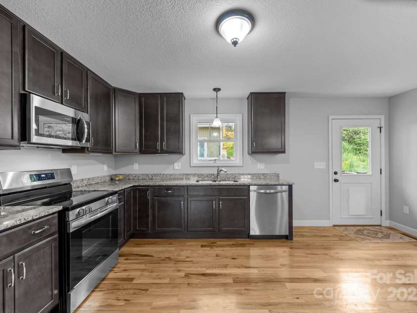 17 Laurel Road, Arden, NC 28704.  MLS# CAR4265020, YatesRealty ID 23009. Kitchen looking towards back door