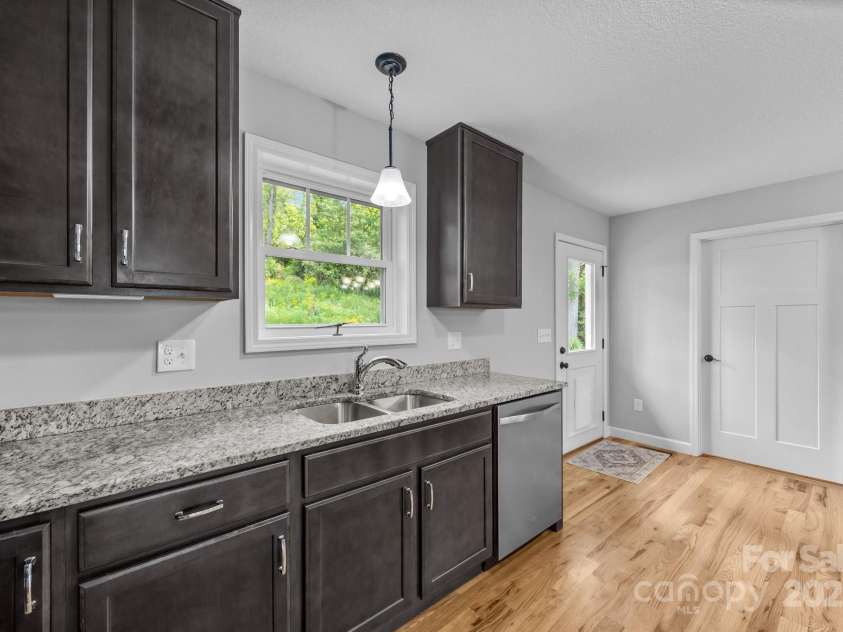 17 Laurel Road, Arden, NC 28704.  MLS# CAR4265020, YatesRealty ID 23009. Kitchen looking towards back door and pantry/laundry room