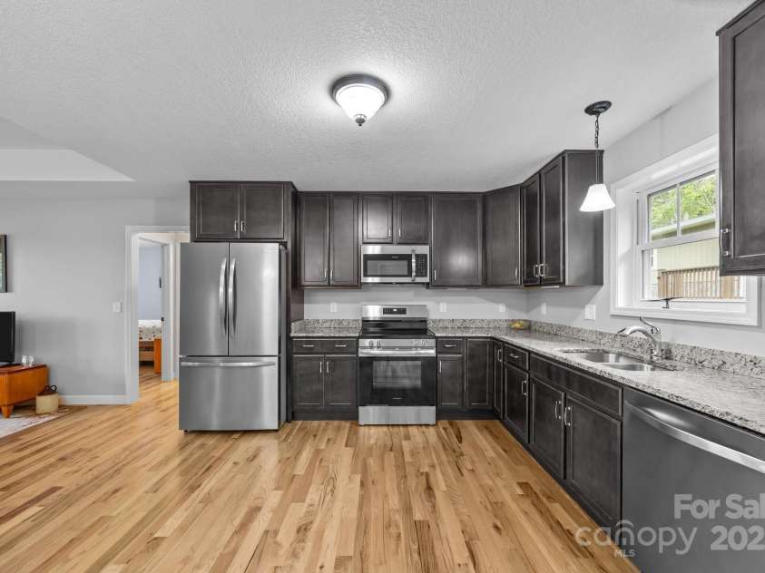 17 Laurel Road, Arden, NC 28704.  MLS# CAR4265020, YatesRealty ID 23009. Kitchen with new refrigerator, convection oven, electric range, and microwave