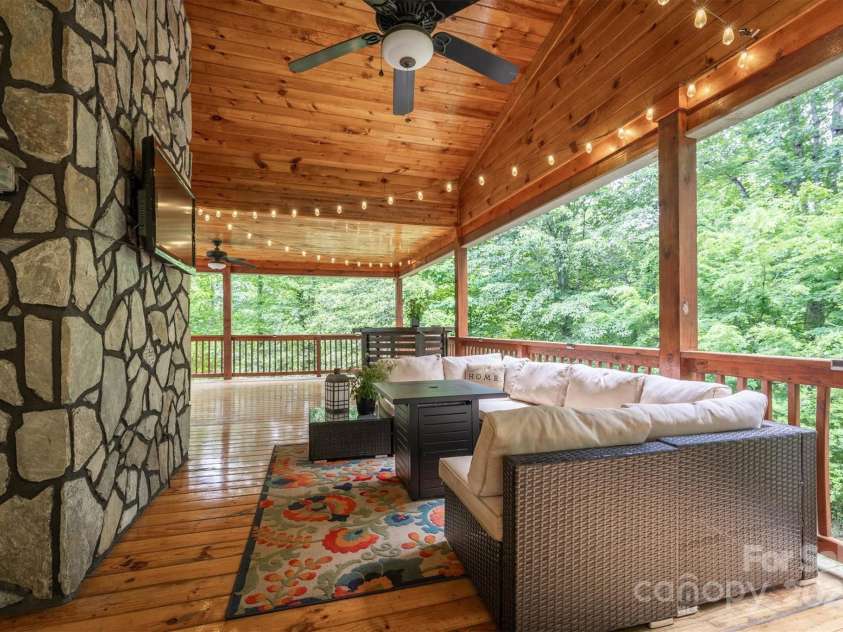 3452 Tranquil Hills Drive, Lenoir, NC 28645.  MLS# CAR4264787, YatesRealty ID 23011. Back covered deck with Rock from back of fireplace on bonus room