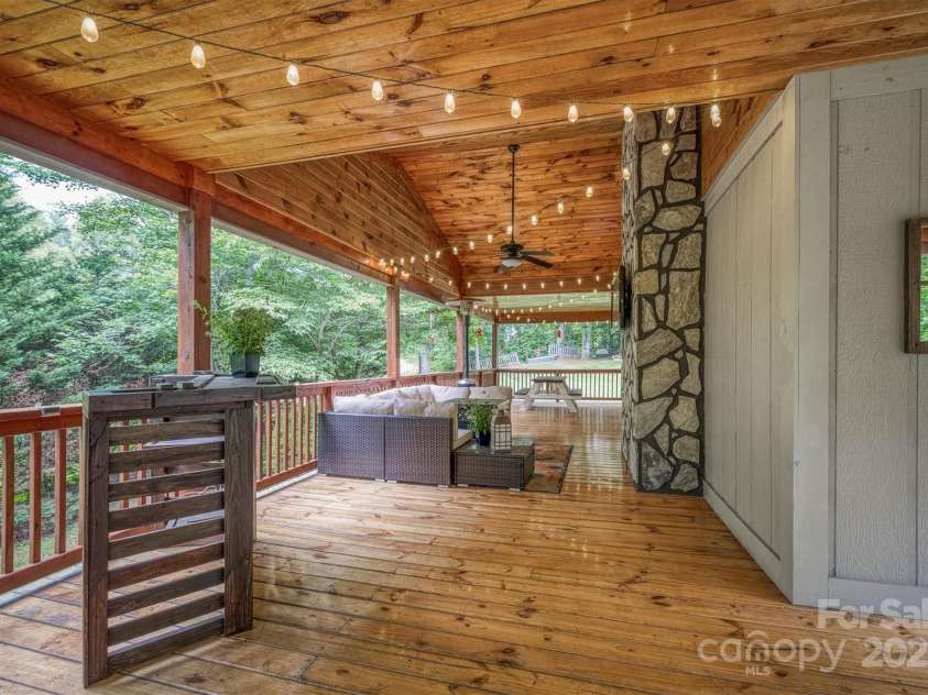 3452 Tranquil Hills Drive, Lenoir, NC 28645.  MLS# CAR4264787, YatesRealty ID 23011. Back covered deck with Rock from back of fireplace on bonus room