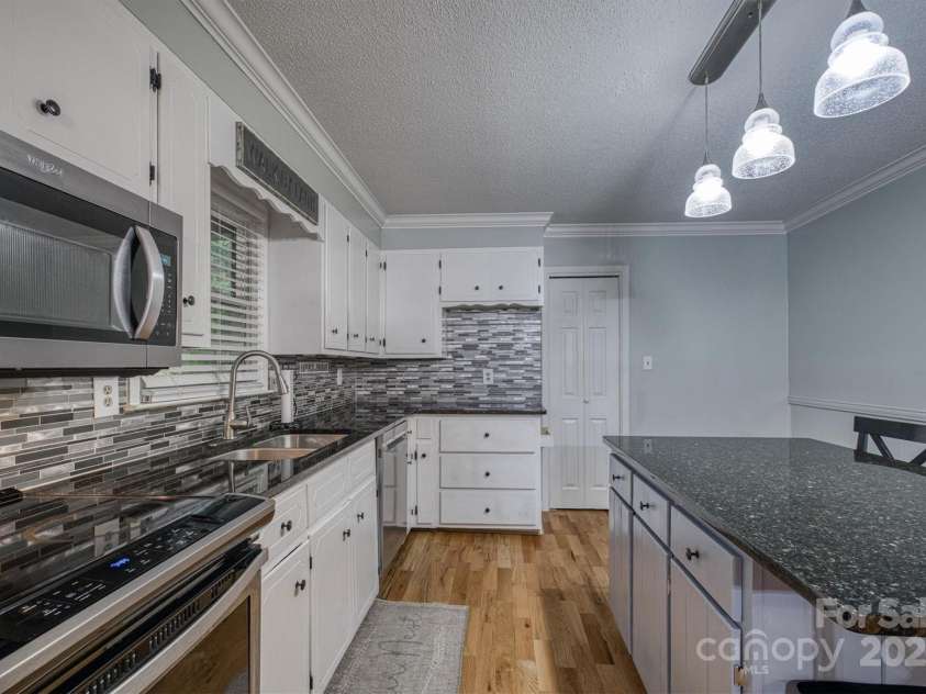 3452 Tranquil Hills Drive, Lenoir, NC 28645.  MLS# CAR4264787, YatesRealty ID 23011. Kitchen with small pantry on back wall