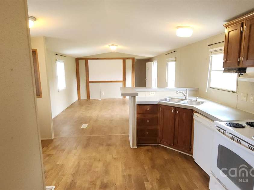 67 Brown Lynch Road, Candler, NC 28715.  MLS# CAR4270634, YatesRealty ID 23018. Kitchen and living room