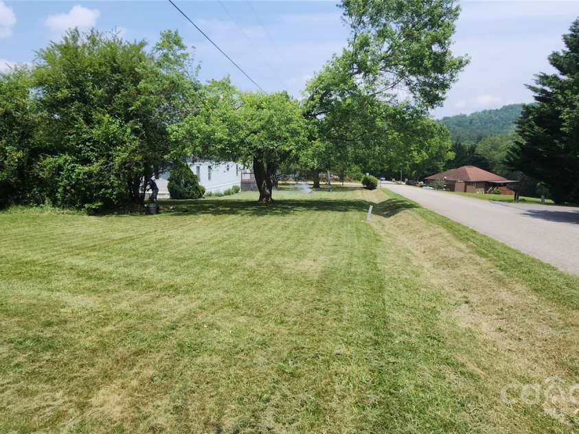 67 Brown Lynch Road, Candler, NC 28715.  MLS# CAR4270634, YatesRealty ID 23018. Standing at corner pin looking back at house from side yard