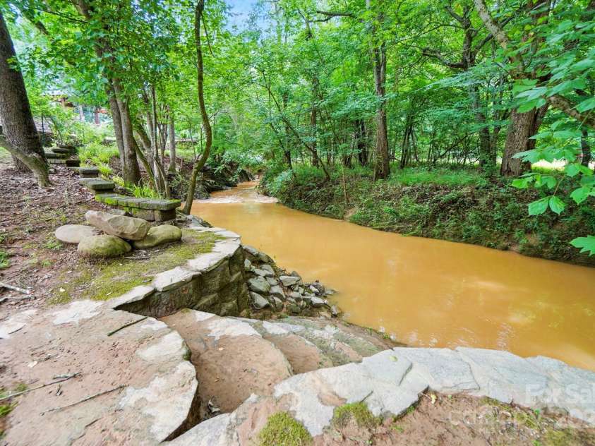 1042 Heather Glen Drive, Matthews, NC 28104.  MLS# CAR4270190, YatesRealty ID 23020. Price Mill Creek at the back of the property