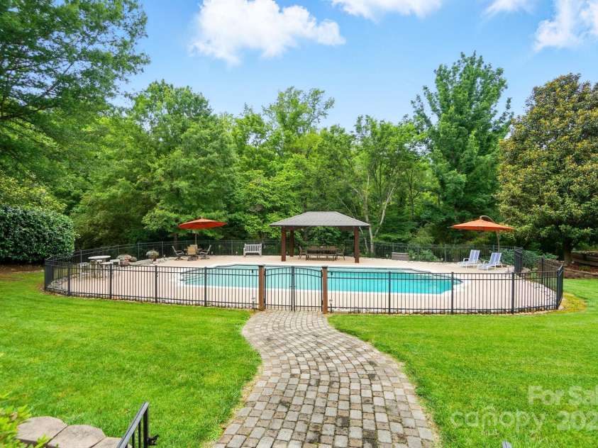 1042 Heather Glen Drive, Matthews, NC 28104.  MLS# CAR4270190, YatesRealty ID 23020. Saltwater, Pebble Tec Pool w/ Rubaroc Deck