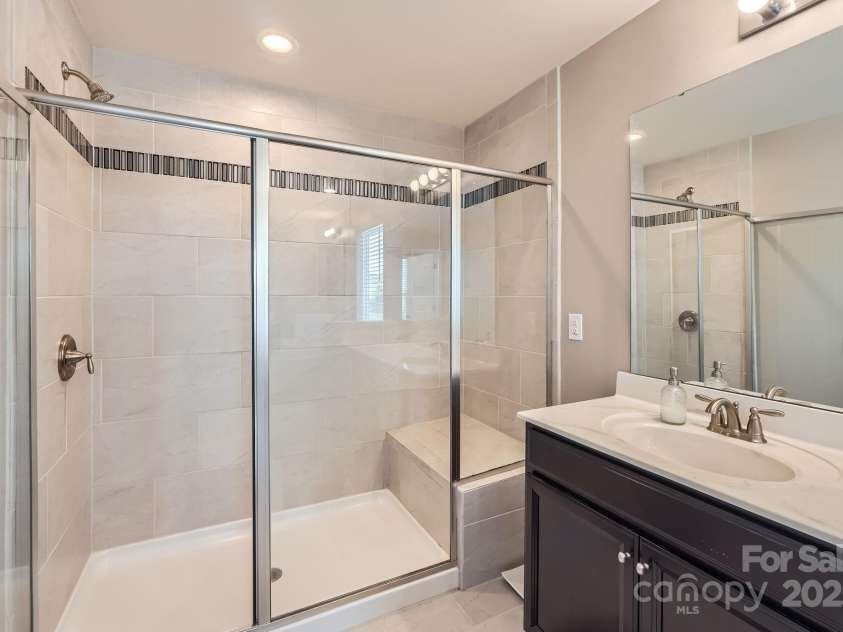 8726 Addingham Drive, Charlotte, NC 28269.  MLS# CAR4257512, YatesRealty ID 23040. 2nd Floor Primary Bathroom - Shower with bench