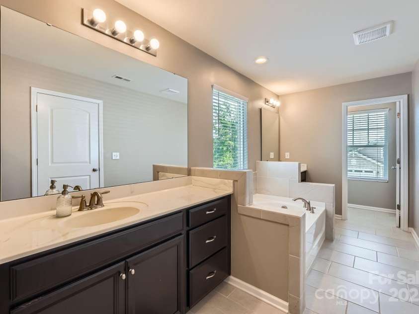 8726 Addingham Drive, Charlotte, NC 28269.  MLS# CAR4257512, YatesRealty ID 23040. 2nd Floor Primary Bathroom Vanity 1