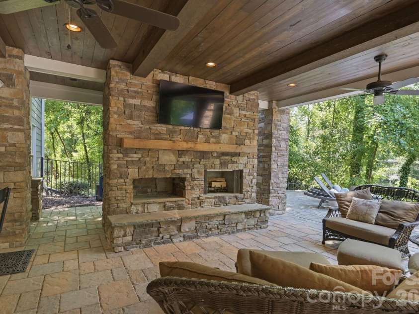 235 Grey Road, Davidson, NC 28036.  MLS# CAR4382846, YatesRealty ID 23048. Lower level fire place and entertainment area