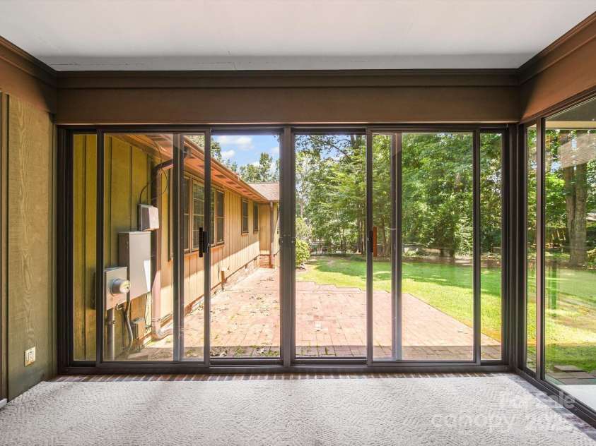 2104 Stoneyridge Drive, Charlotte, NC 28214.  MLS# CAR4275022, YatesRealty ID 23053. Enclosed back porch