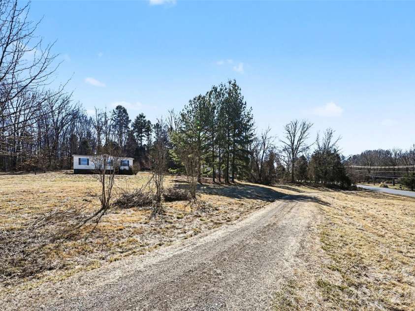 4650 Windy Road, Concord, NC 28027.  MLS# CAR4347275, YatesRealty ID 2307. Exterior facing doublewide from brick house