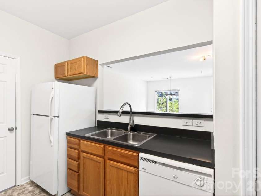 64 Clingman Avenue, Asheville, NC 28801.  MLS# CAR4371105, YatesRealty ID 23076. Kitchen view into living space.