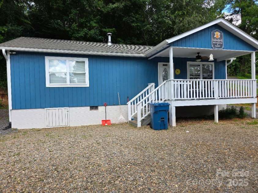 14 Yellow Brick Lane, Burnsville, NC 28714.  MLS# CAR4273450, YatesRealty ID 23082. Another view of the front of the house with crawl space access on the left side.