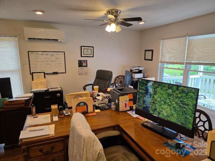 14 Yellow Brick Lane, Burnsville, NC 28714.  MLS# CAR4273450, YatesRealty ID 23082. Front windows with ceiling fan and mini split #2 visible. Front deck is visible through double window