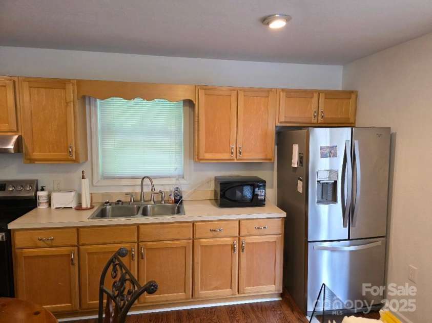 14 Yellow Brick Lane, Burnsville, NC 28714.  MLS# CAR4273450, YatesRealty ID 23082. Kitchen with large double door refrigerator