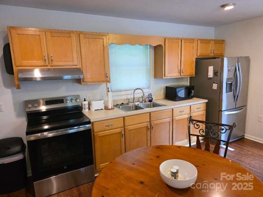 14 Yellow Brick Lane, Burnsville, NC 28714.  MLS# CAR4273450, YatesRealty ID 23082. Kitchen with new range and new oven hood