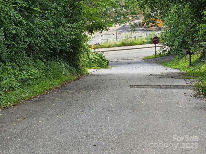 14 Yellow Brick Lane, Burnsville, NC 28714.  MLS# CAR4273450, YatesRealty ID 23082. View of Reid Street with the intersection with Mitchell Branch and Ray Cort Park in the background.