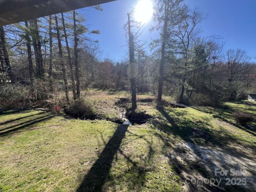 1757 Rosman Highway, Brevard, NC 28712.  MLS# CAR4234818, YatesRealty ID 2310. Stream in Back Yard