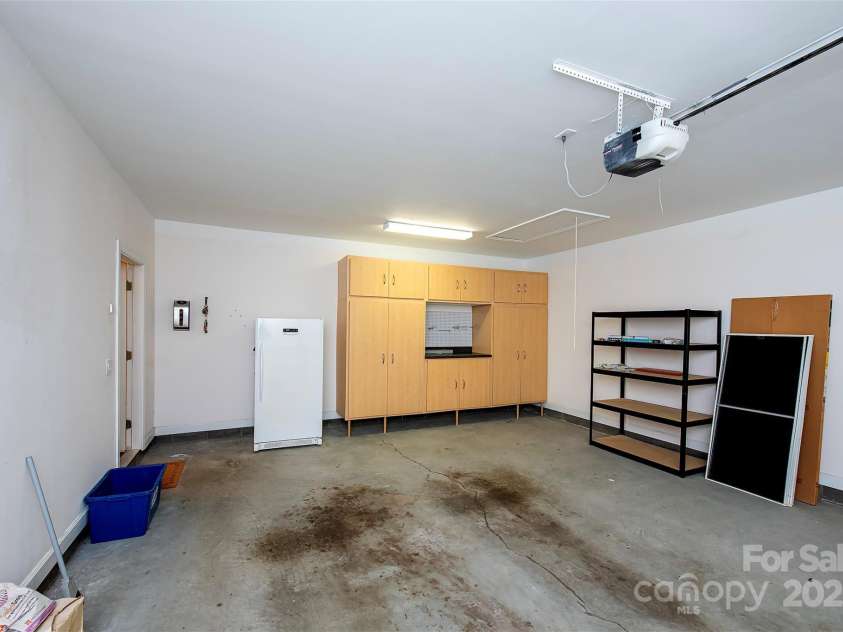 8538 Highland Glen Drive, Charlotte, NC 28269.  MLS# CAR4270032, YatesRealty ID 23101. Large 2 car garage, with built in cabinets, shelving.